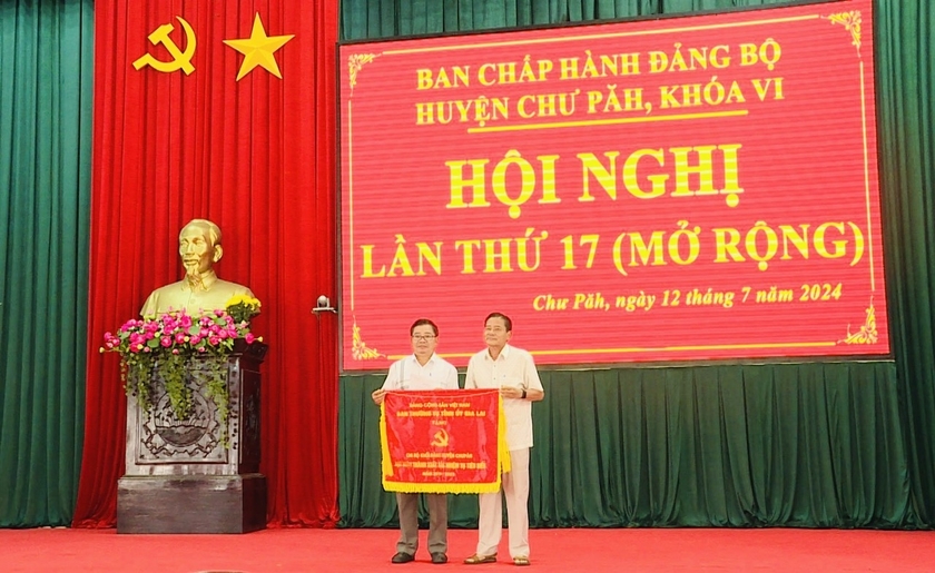 Ông Trần Ngọc Nhung (bìa phải)-Giám đốc Sở Văn hóa-Thể thao và Du lịch trao cờ thi đua của Ban Thường vụ Tỉnh ủy Gia Lai cho Chi bộ Khối Đảng (Huyện ủy Chư Păh) vì đã hoàn thành xuất sắc nhiệm vụ tiêu biểu 5 năm liền (2019-2023). Ảnh: Văn Cảnh