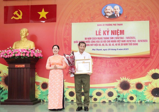 Phó Bí thư Thường trực Đảng ủy phường Phú Thạnh Nguyễn Thị Chiên trao Huy hiệu Đảng đến đảng viên