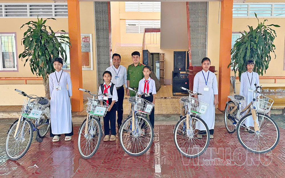 Chi bộ Công an xã Đôn Châu trao học bổng hỗ trợ học sinh. Ảnh: NGỌC XOÀN