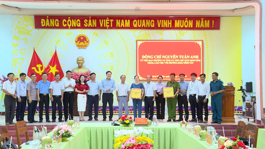 Phó Chủ tịch UBND tỉnh Nguyễn Tuấn Anh (thứ 10 từ phải sang) tặng quà của Tỉnh ủy, HĐND, UBND, Ủy ban MTTQ Việt Nam tỉnh cho lãnh đạo và Công an phường Hoài Nhơn Tây. Ảnh: Phi Long z6810722845095-24655ef2be4bdaba7b44398a066fb6d6.jpg