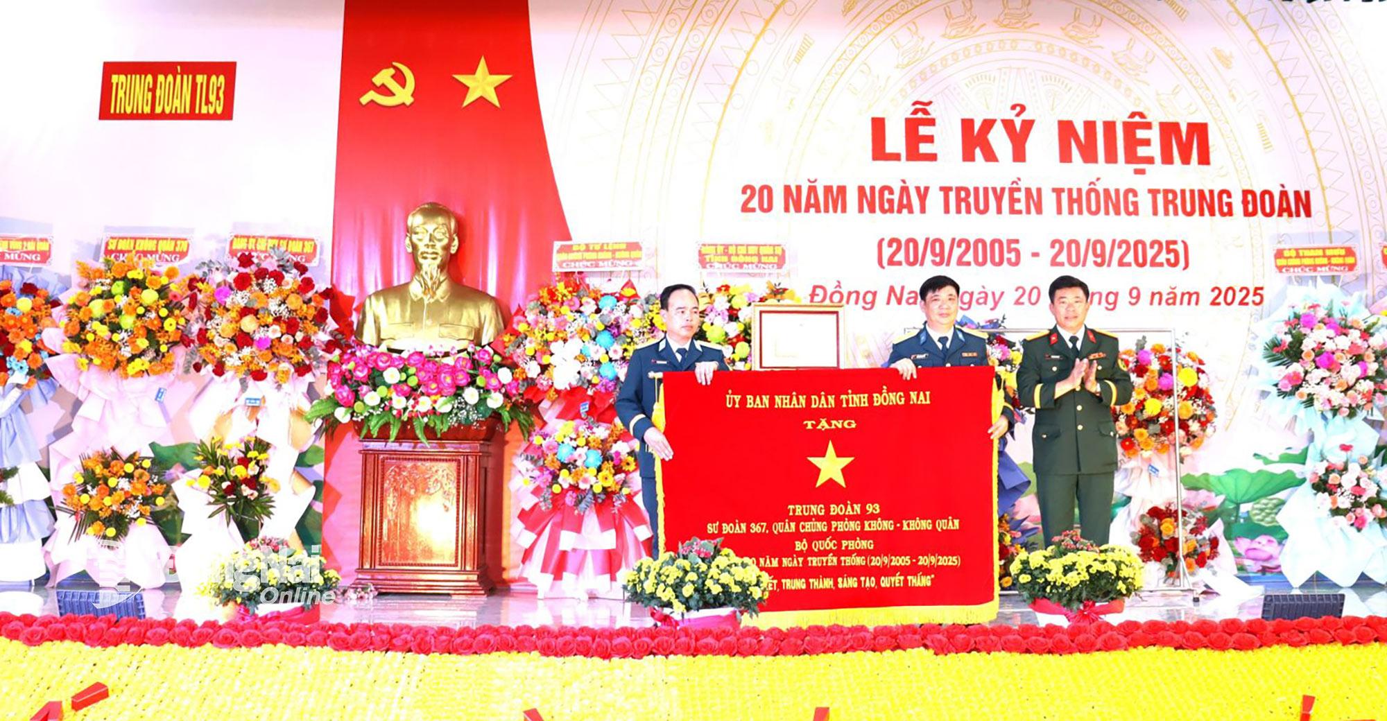 Thượng tá Phạm Minh Trí, Phó Chỉ huy trưởng Bộ Chỉ huy Quân sự tỉnh Đồng Nai (bìa phải), thừa ủy quyền của Chủ tịch UBND tỉnh trao tặng Trung đoàn 93 bức trướng của UBND tỉnh có nội dung: “Đoàn kết, trung thành, sáng tạo, quyết thắng” nhân kỷ niệm 20 năm ngày truyền thống đơn vị. Ảnh: Nguyệt Hà