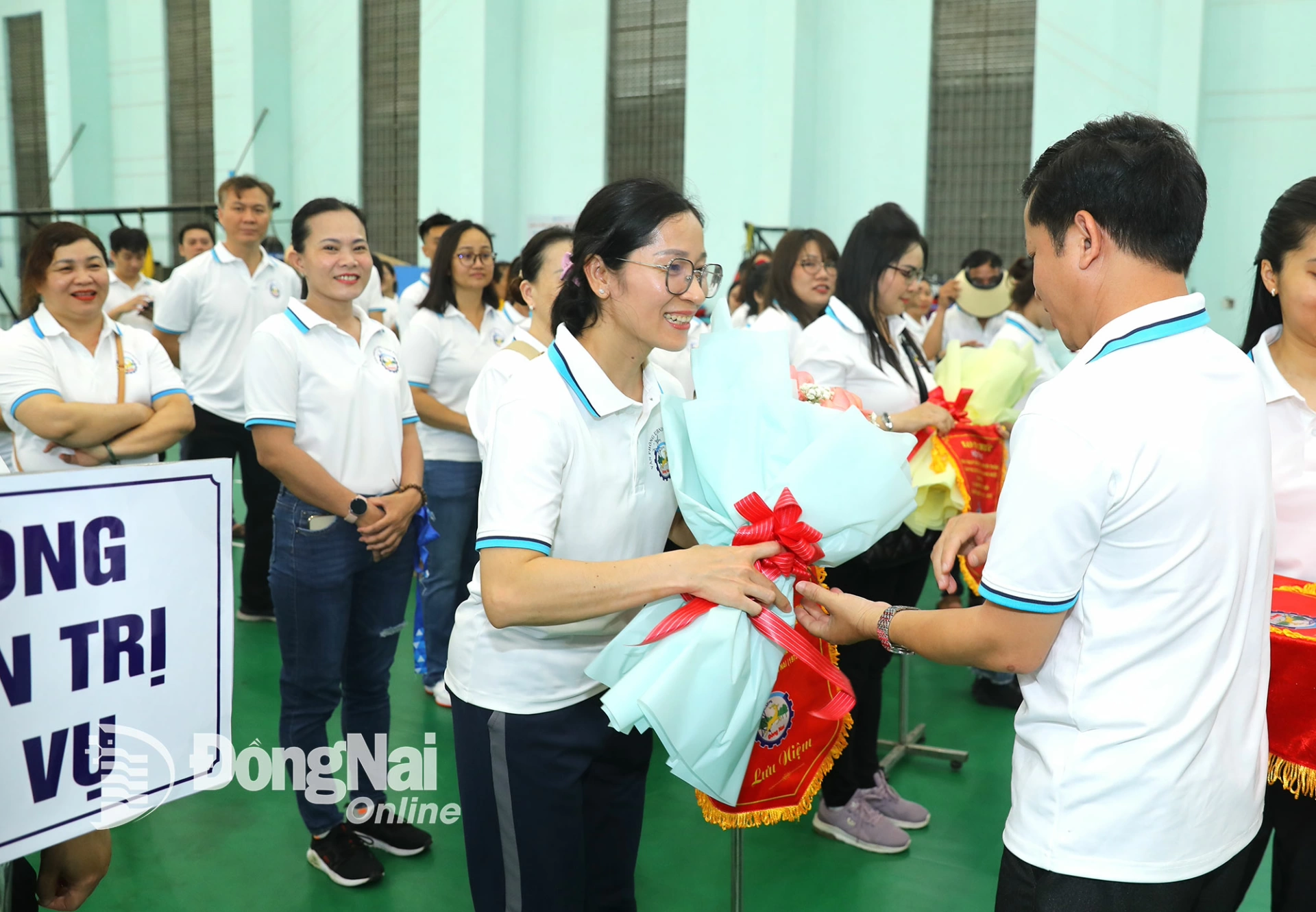 Ban tổ chức tặng cờ lưu niệm và hoa cho các đơn vị tham dự hội thao. Ảnh: Huy Anh