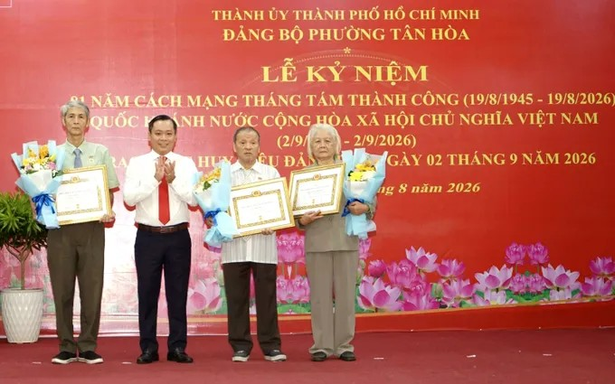 Bí thư Đảng ủy phường Tân Hòa Đoàn Văn Đồng trao Huy hiệu Đảng đến các đảng viên