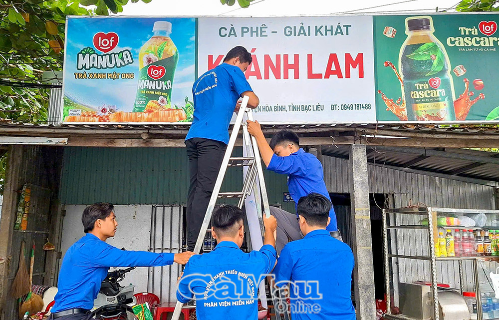 Đoàn viên – thanh niên xã hỗ trợ từng hộ kinh doanh thay đổi địa chỉ, số điện thoại trên bảng hiệu cho phù hợp với địa giới hành chính mới sau hợp nhất tỉnh.